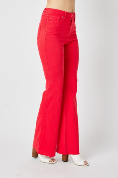 red low rise flared jeans with raw hem, detail close-up